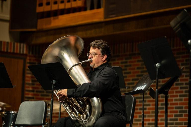 Dr. Cottrell playing the tuba during a former concert.